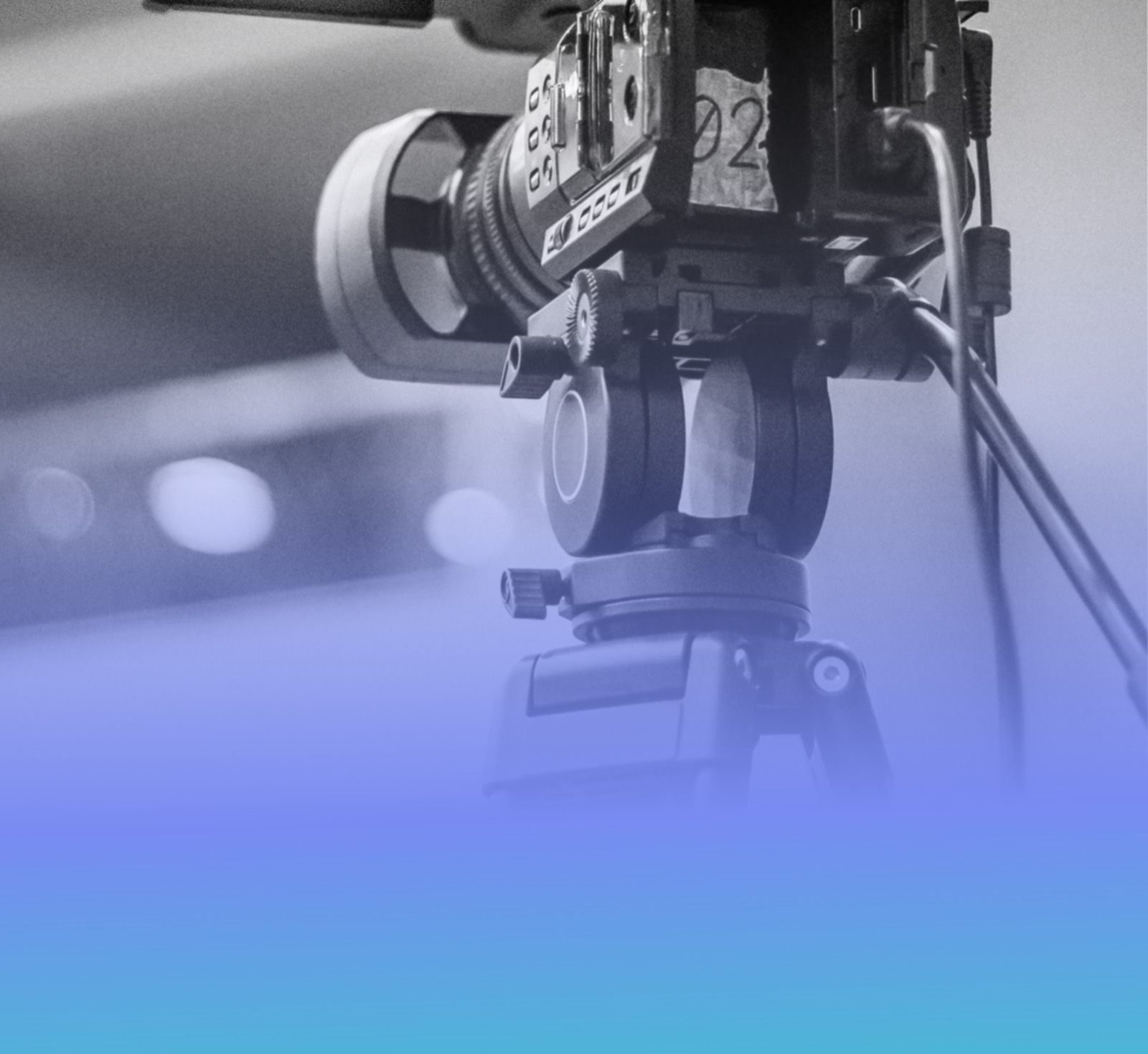 A professional video camera on a tripod at an event