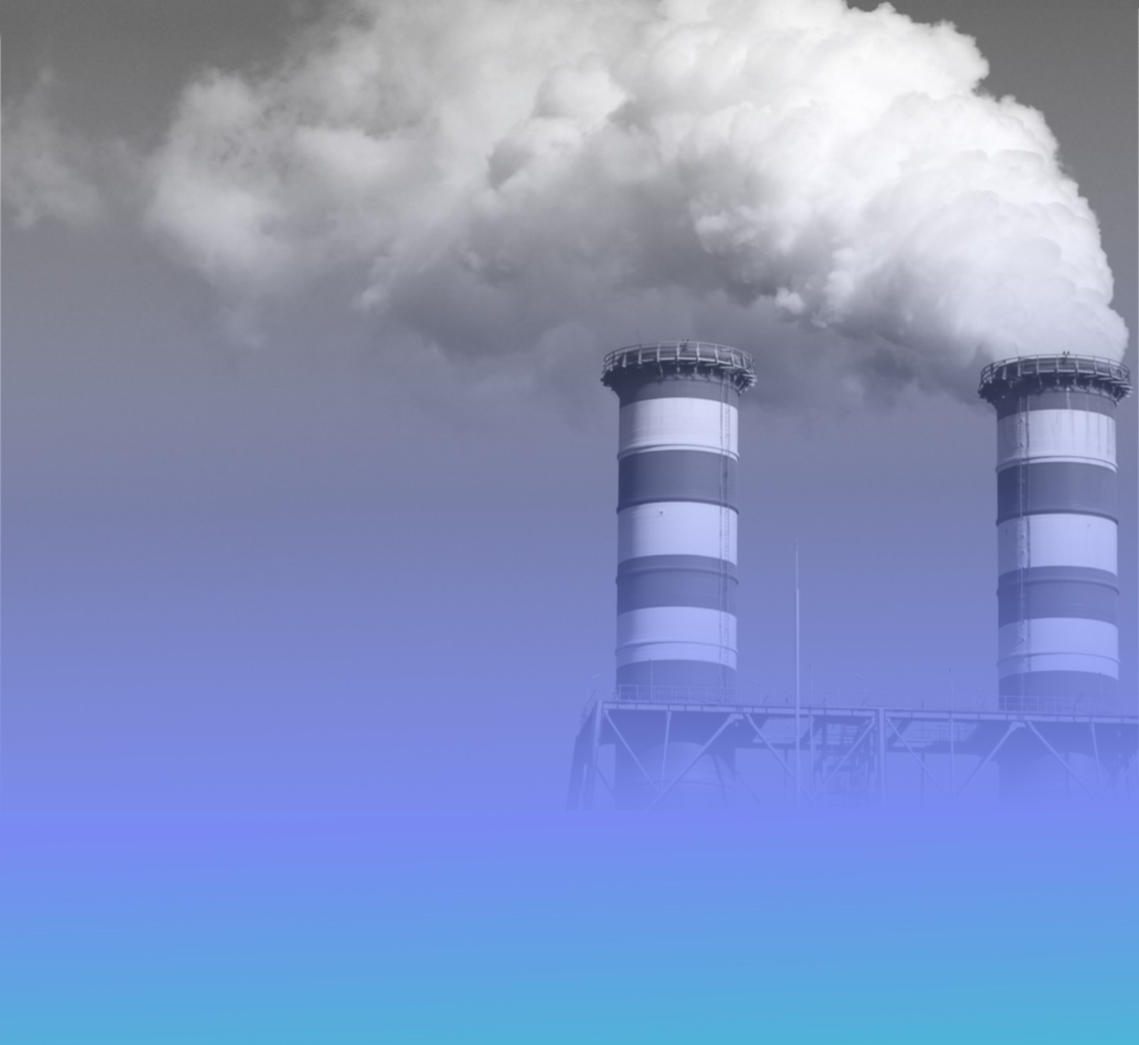 Industrial plant chimneys releasing steam against the sky